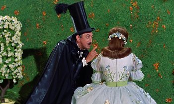 Movie still from “Babes in Toyland” (1961), directed by Jack Donohue – A man and a woman dressed in costumes; Medium shot, Over the shoulder angle