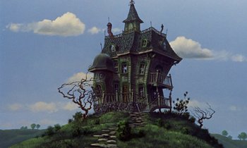 Movie still from “Babes in Toyland” (1961), directed by Jack Donohue – A painting of an old house on a hill; Extreme Wide shot, Low angle