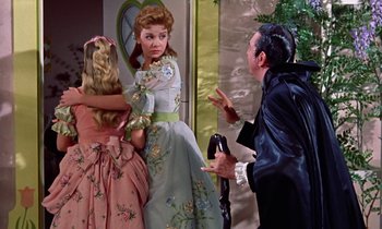 Movie still from “Babes in Toyland” (1961), directed by Jack Donohue – Two women and a man dressed in period costumes; Medium shot, Low angle