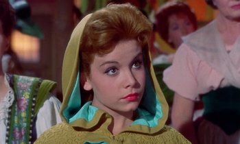 Movie still from “Babes in Toyland” (1961), directed by Jack Donohue – A person wearing a hooded jacket; Close Up shot, Over the shoulder angle