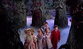 Movie still from “Babes in Toyland” (1961), directed by Jack Donohue – A group of children dressed in costumes in a wooded area; Medium shot, Low angle