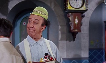 Movie still from “Babes in Toyland” (1961), directed by Jack Donohue – A person holding a tray of food; Medium shot, Low angle
