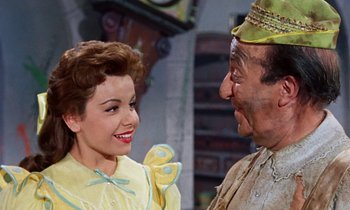 Movie still from “Babes in Toyland” (1961), directed by Jack Donohue – A man and a woman smiling at each other; Medium shot, Over the shoulder angle