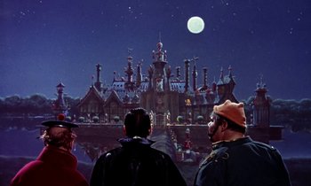 Movie still from “Babes in Toyland” (1961), directed by Jack Donohue – A group of people standing in front of a building at night; Extreme Wide shot, Low angle