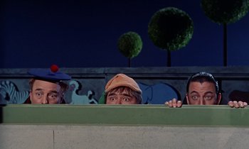 Movie still from “Babes in Toyland” (1961), directed by Jack Donohue – A group of three men standing next to each other; Medium shot, Low angle