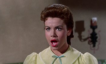 Movie still from “Babes in Toyland” (1961), directed by Jack Donohue – A woman with a surprised look on her face; Close Up shot, Low angle