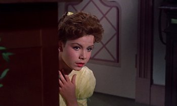 Movie still from “Babes in Toyland” (1961), directed by Jack Donohue – A young woman in a yellow dress looking at the camera; Close Up shot, Low angle