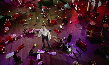 Movie still from “Babes in Toyland” (1961), directed by Jack Donohue – A man standing on the floor of an empty room; Extreme Wide shot, Overhead angle