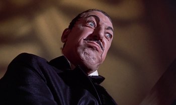 Movie still from “Babes in Toyland” (1961), directed by Jack Donohue – The face of a wax statue of a man; Close Up shot, Low angle