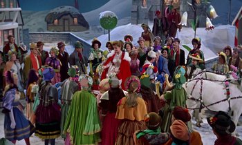 Movie still from “Babes in Toyland” (1961), directed by Jack Donohue – A group of people dressed up in costumes and hats; Wide shot, High angle