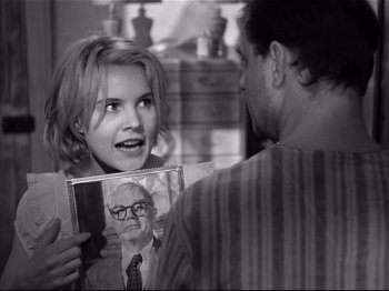 Movie still from “Baby Doll” (1956), directed by Elia Kazan – A young girl holding a picture of a man; Close Up shot, Over the shoulder angle
