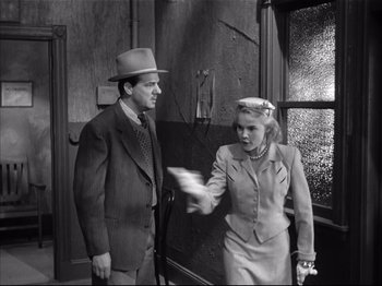 Movie still from “Baby Doll” (1956), directed by Elia Kazan – A man and a woman are standing next to each other; Medium shot, Low angle