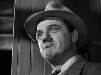 Movie still from “Baby Doll” (1956), directed by Elia Kazan – A black and white photo of a man wearing a hat; Close Up shot, Low angle