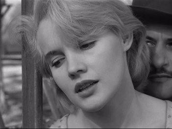 Movie still from “Baby Doll” (1956), directed by Elia Kazan – A woman's face in black - and - white; Close Up shot, Over the shoulder angle