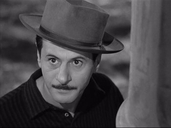 Movie still from “Baby Doll” (1956), directed by Elia Kazan – A black and white photo of a man wearing a hat; Close Up shot, High angle