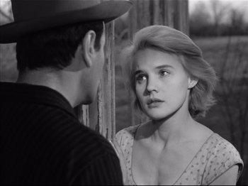 Movie still from “Baby Doll” (1956), directed by Elia Kazan – A man and a woman looking at one another; Close Up shot, Over the shoulder angle