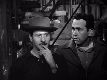 Movie still from “Baby Doll” (1956), directed by Elia Kazan – A man in a hat and a man in a suit and tie; Medium shot, High angle