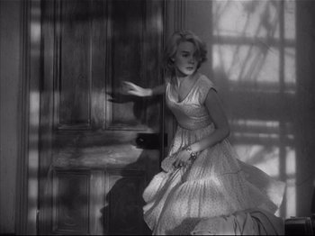 Movie still from “Baby Doll” (1956), directed by Elia Kazan – A black and white photo of a woman in a dress; Medium shot, Low angle