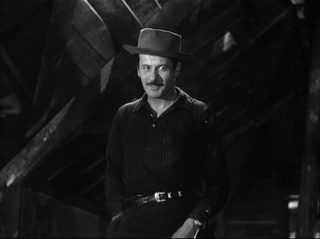 Movie still from “Baby Doll” (1956), directed by Elia Kazan – A black and white photo of a man wearing a hat; Medium shot, Low angle