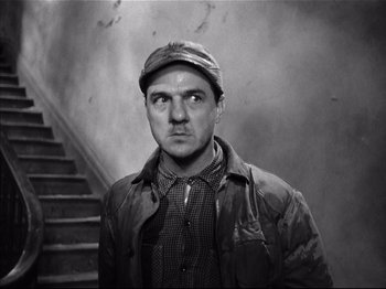 Movie still from “Baby Doll” (1956), directed by Elia Kazan – A black and white photo of a man with a hat; Medium shot, Low angle