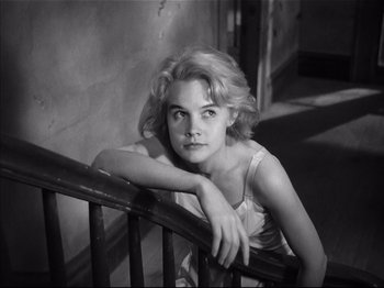 Movie still from “Baby Doll” (1956), directed by Elia Kazan – Black and white photograph of a woman leaning on a railing; Close Up shot, Low angle