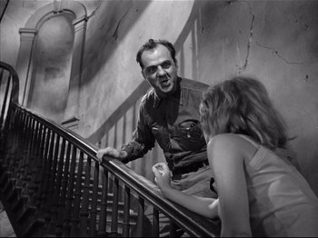 Movie still from “Baby Doll” (1956), directed by Elia Kazan – A man and a woman talking on the stairs; Medium shot, Low angle