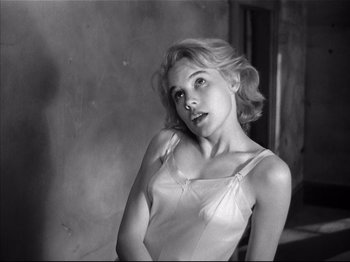Movie still from “Baby Doll” (1956), directed by Elia Kazan – A black - and - white photo of a woman in a white dress; Close Up shot, High angle