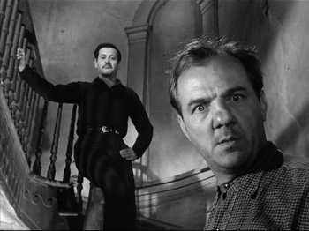 Movie still from “Baby Doll” (1956), directed by Elia Kazan – Two men are posing for a picture on a staircase; Medium shot, Low angle