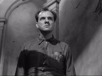 Movie still from “Baby Doll” (1956), directed by Elia Kazan – A black and white photo of a man looking up; Close Up shot, Low angle