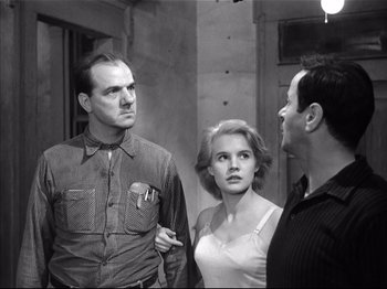 Movie still from “Baby Doll” (1956), directed by Elia Kazan – Two men and a woman standing next to each other; Medium shot, Low angle