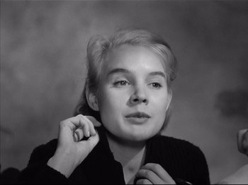 Movie still from “Baby Doll” (1956), directed by Elia Kazan – A young blonde woman posing for a picture; Close Up shot, High angle