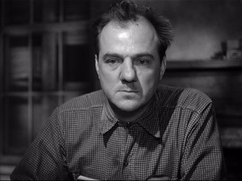 Movie still from “Baby Doll” (1956), directed by Elia Kazan – Black and white photograph of a man in a checkered shirt; Close Up shot, Low angle