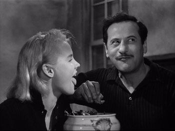 Movie still from “Baby Doll” (1956), directed by Elia Kazan – A man and a woman are eating food together; Close Up shot, Low angle