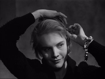 Movie still from “Baby Doll” (1956), directed by Elia Kazan – A young woman is holding her hands up to her head; Close Up shot, Low angle