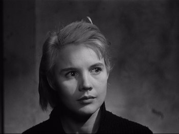 Movie still from “Baby Doll” (1956), directed by Elia Kazan – Black and white photograph of a young woman in a black shirt; Close Up shot, Low angle
