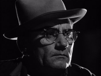 Movie still from “Baby Doll” (1956), directed by Elia Kazan – An older man wearing glasses and a hat; Close Up shot, Low angle