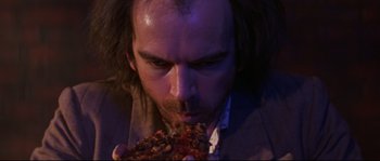 A person eating a piece of pizza