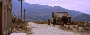 Movie still from “Bad Day at Black Rock” (1955), directed by John Sturges – A man walking down a dirt road in the middle of the desert; Extreme Wide shot, Low angle