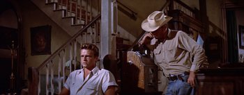 Movie still from “Bad Day at Black Rock” (1955), directed by John Sturges – A man in a cowboy hat standing next to another man; Medium shot, Low angle
