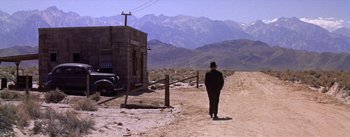 Movie still from “Bad Day at Black Rock” (1955), directed by John Sturges – A man walking down a dirt road in the desert; Extreme Wide shot, Low angle