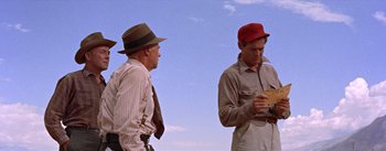 Movie still from “Bad Day at Black Rock” (1955), directed by John Sturges – A couple of men standing next to each other on top of a hill; Medium shot, Low angle