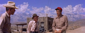 Movie still from “Bad Day at Black Rock” (1955), directed by John Sturges – Two men standing next to each other in front of a building; Medium shot, Low angle