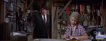 Movie still from “Bad Day at Black Rock” (1955), directed by John Sturges – A man in a suit and a woman in a plaid shirt; Medium shot, Over the shoulder angle