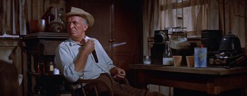 Movie still from “Bad Day at Black Rock” (1955), directed by John Sturges – An older man sitting in a chair in front of a camera; Medium shot, Low angle
