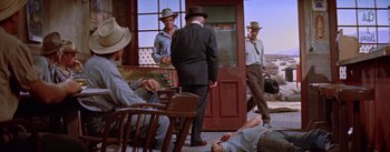 Movie still from “Bad Day at Black Rock” (1955), directed by John Sturges – A group of men standing in front of a door; Wide shot, High angle