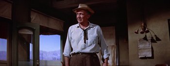 Movie still from “Bad Day at Black Rock” (1955), directed by John Sturges – An older man wearing a hat standing in a room; Medium shot, Low angle
