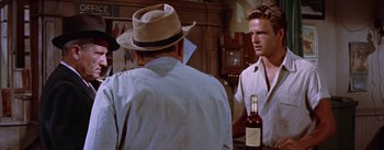 Movie still from “Bad Day at Black Rock” (1955), directed by John Sturges – A man in a hat is talking to another man in a hat; Medium shot, Over the shoulder angle