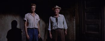 Movie still from “Bad Day at Black Rock” (1955), directed by John Sturges – A man and a boy standing next to each other; Medium shot, Low angle