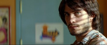 Movie still from “Bad Education” (2004), directed by Pedro Almodóvar – A person with long hair and a beard; Close Up shot, Low angle