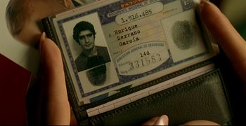 Movie still from “Bad Education” (2004), directed by Pedro Almodóvar – A person holding a wallet with a picture of a man in it; Extreme Close Up shot, High angle